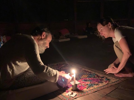 Pouring Ayahuasca for a guest at an Ayahuasca ceremony in Caya Shobo's traditional maloka